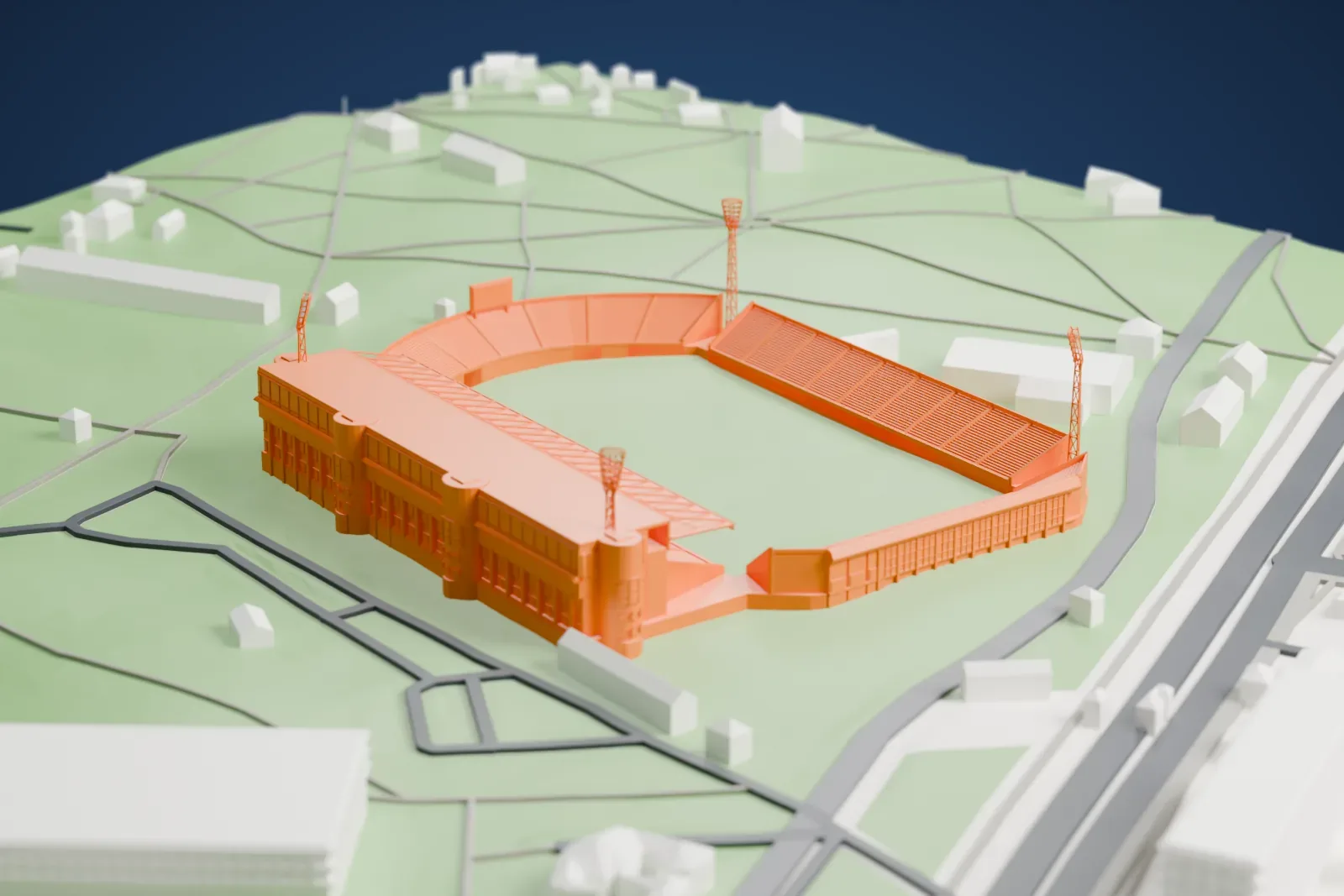 A white 3D print of Olimp-2, a football stadium with raked stands, floodlight masts and a central pitch, among the surrounding streets and open ground.