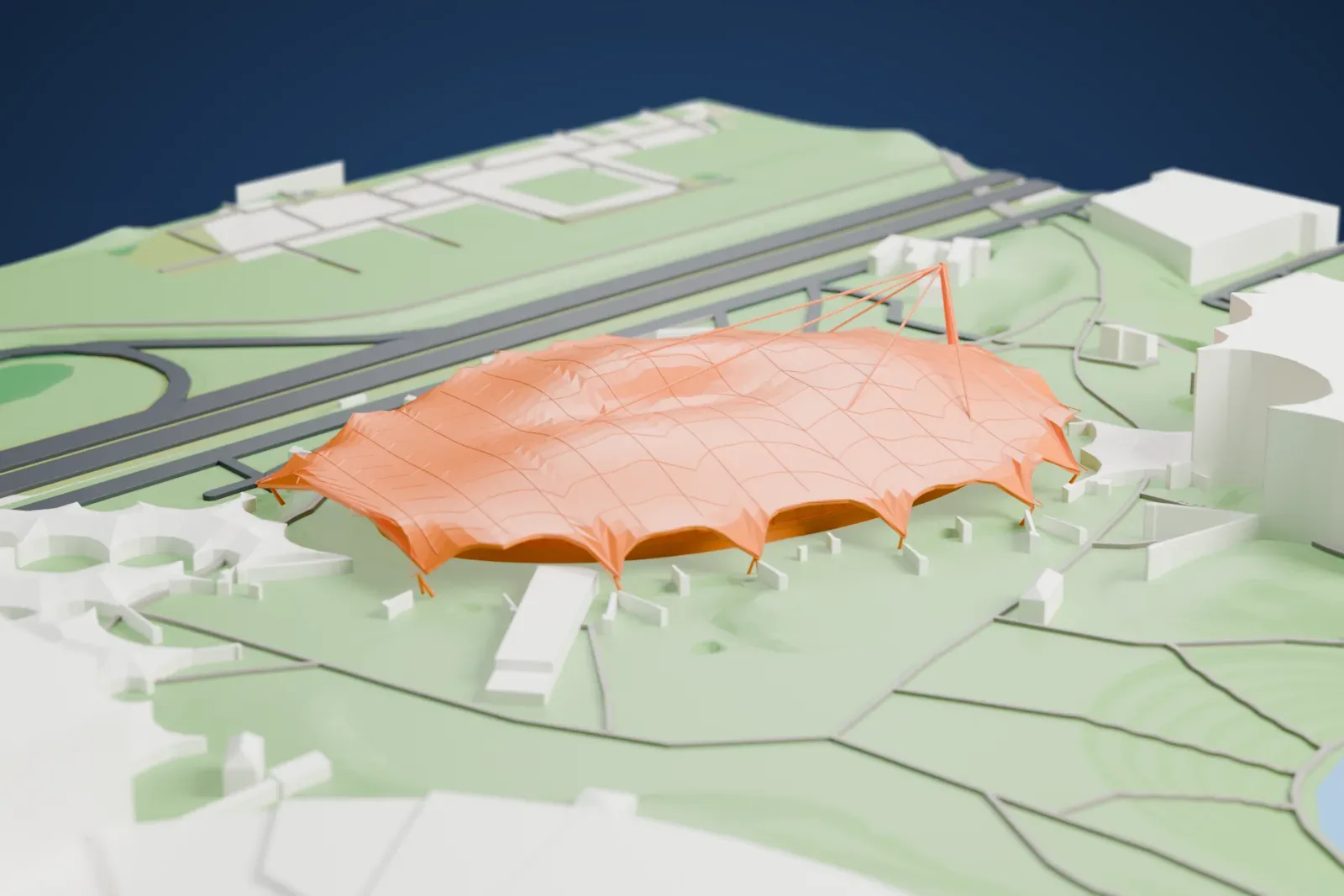 A white 3D print of the Olympiahalle, a wide building mass on its footprint, with the buildings and grounds of Olympiapark around it.