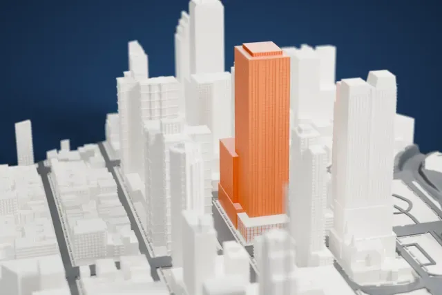 A white 3D print of the One MiMA Tower model in New York, with the streets around it.