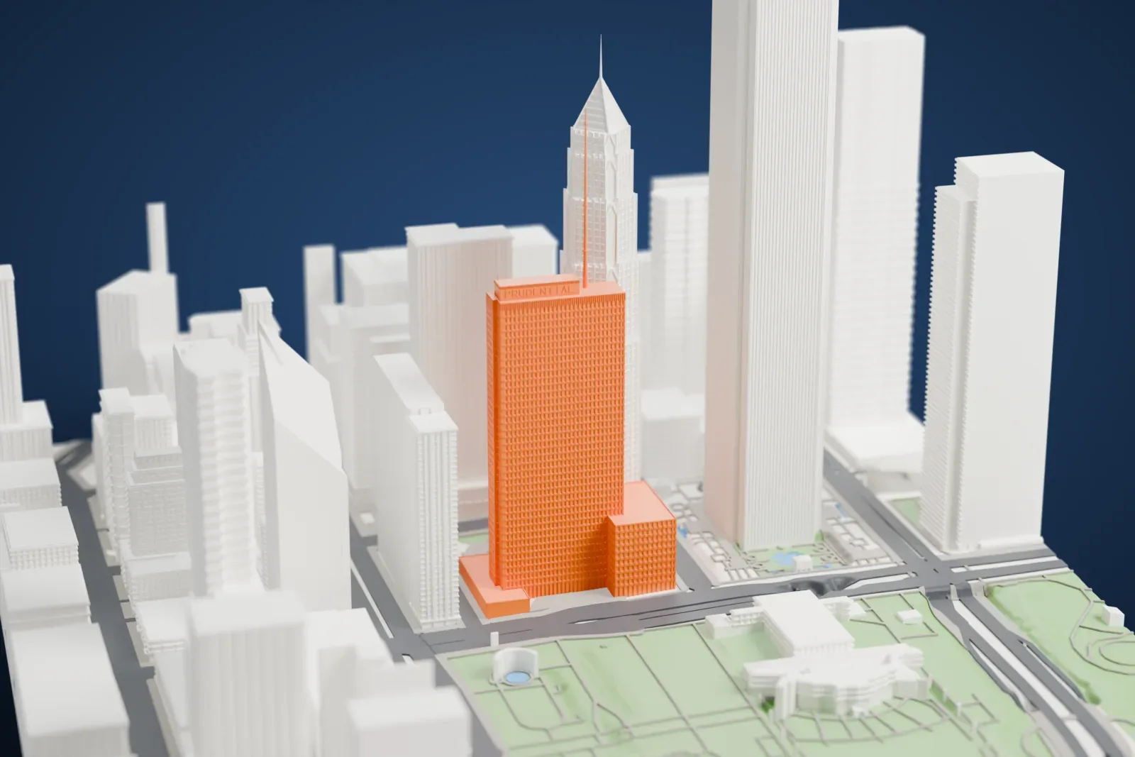 A white 3D print of One Prudential Plaza, a tall tower among the surrounding streets and buildings.