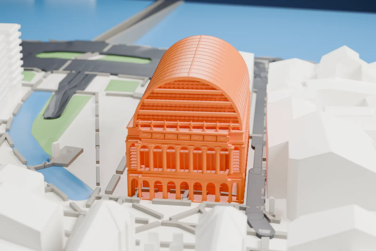 A white 3D print of the Opéra de Lyon with its curved roof and rows of arches, surrounded by streets and closely spaced buildings.