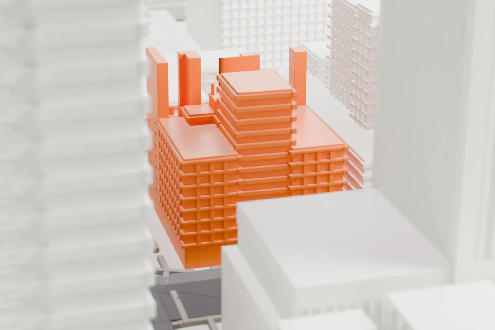 A white 3D print of the Orpheum Lofts, a stepped tower with a notched parapet crown, standing between wider downtown streets and neighboring tall blocks.