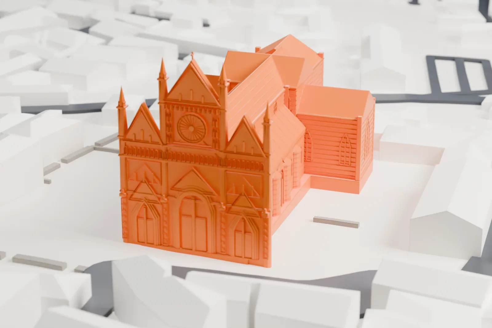 A white 3D print of Orvieto Cathedral, a long church with a three-gabled front, a round rose window, slender spires beside the facade and banded side walls, among closely packed buildings.