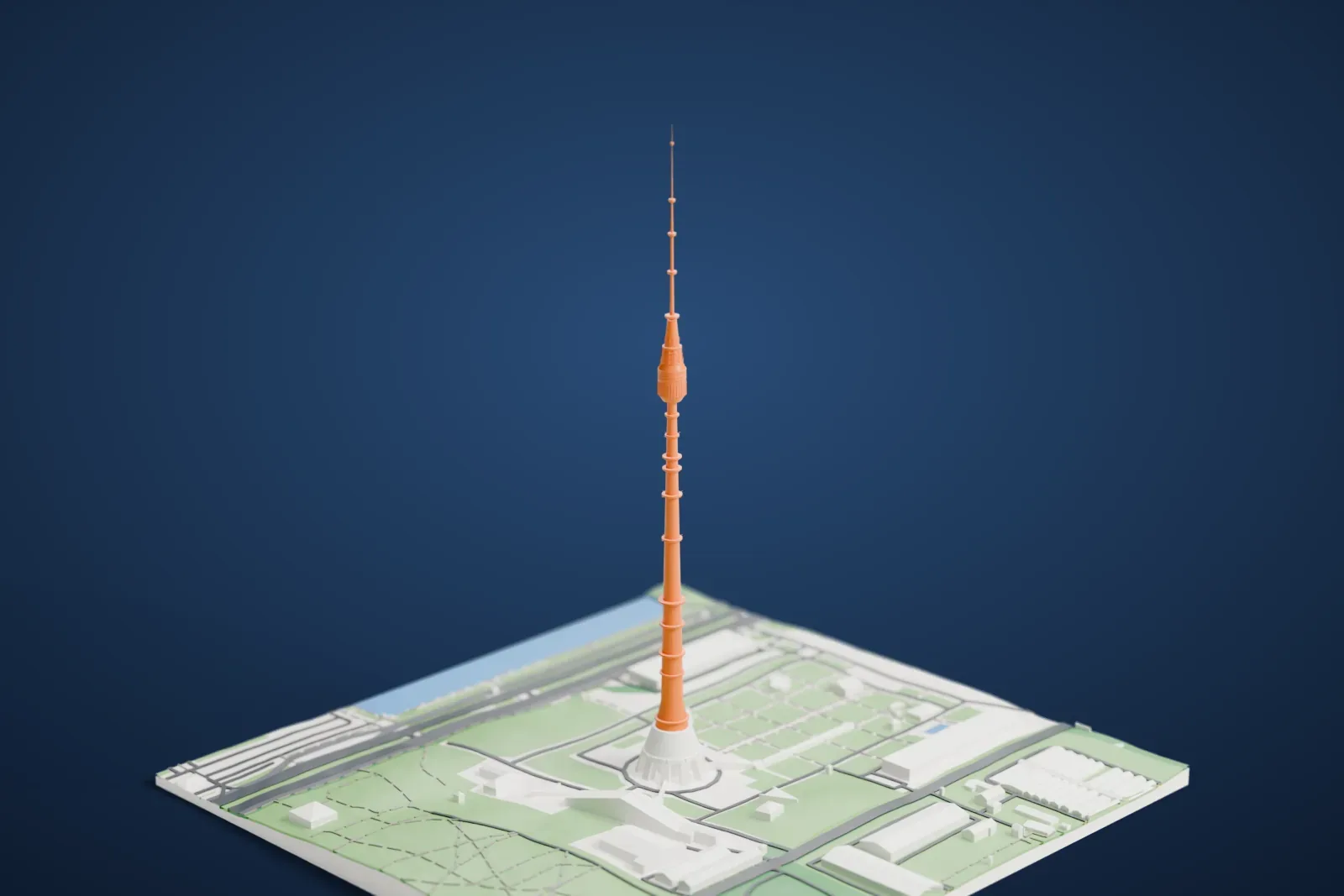 A white 3D print of the Ostankino Tower, a slender tower with a rounded pod near the top, standing on open green ground with roads and a few buildings.