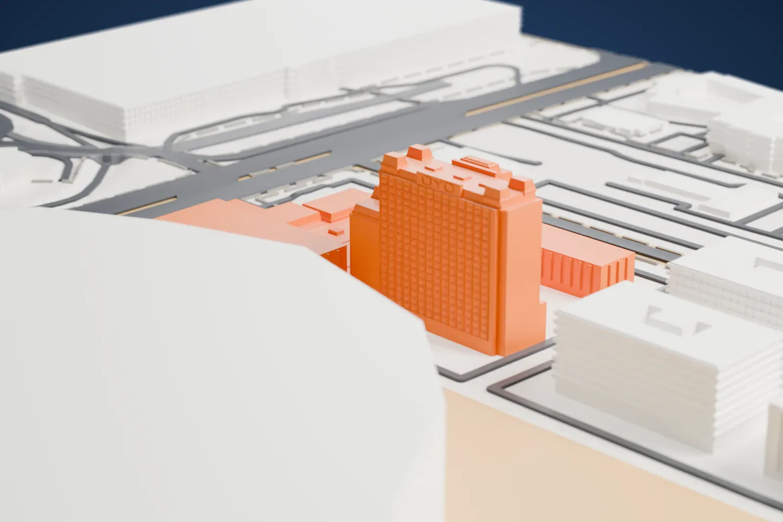 A white 3D print of the Oyo Hotel & Casino, a cluster of tower blocks and lower wings, surrounded by roads, gray buildings and open ground.
