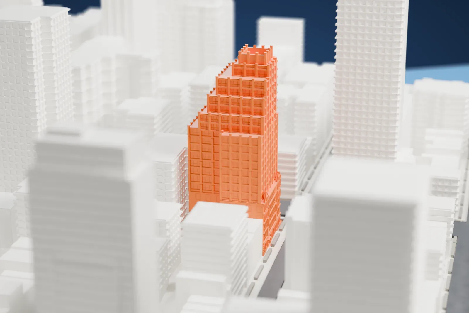 A white 3D print of P.S. 135, a stepped tower with a detailed arched base, rising between neighboring high-rises in dense city streets.