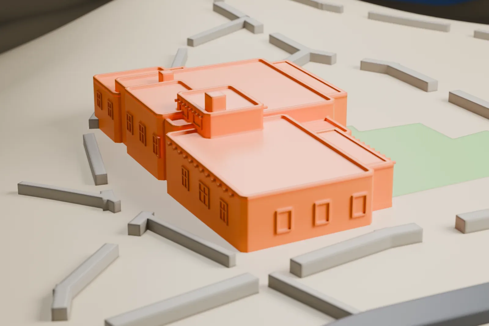 A white 3D print of the Painted Desert Inn with stepped flat roofs and small porches, surrounded by open ground with a road nearby.