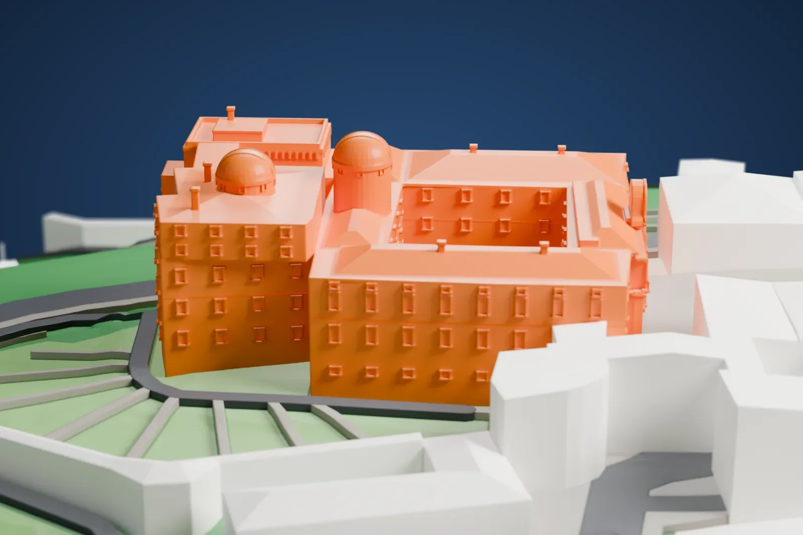 A white 3D print of the Palace of Castel Gandolfo, a long villa with garden grounds beside it, among the streets and buildings of the town.