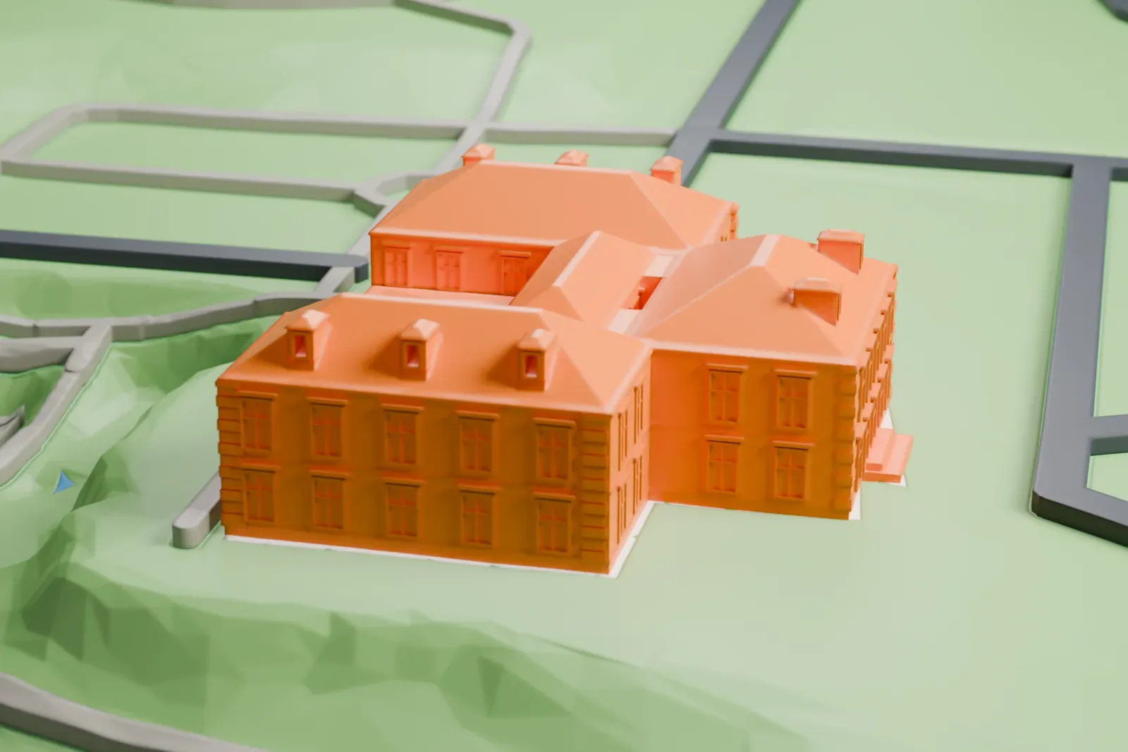 A white 3D print of the Palace of Moncloa among the surrounding streets and buildings of Madrid.