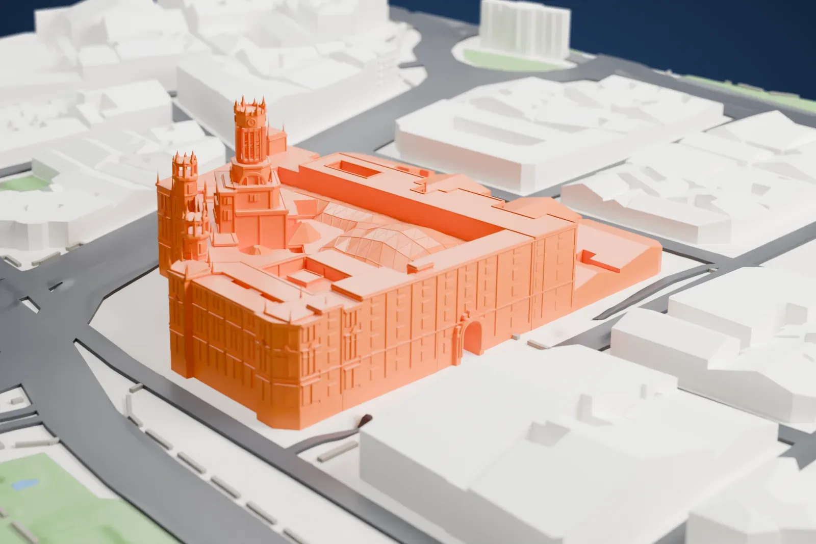A white 3D print of the Palacio de Cibeles, a large block with a lattice courtyard roof, a central tower and corner turrets, beside wide roads.