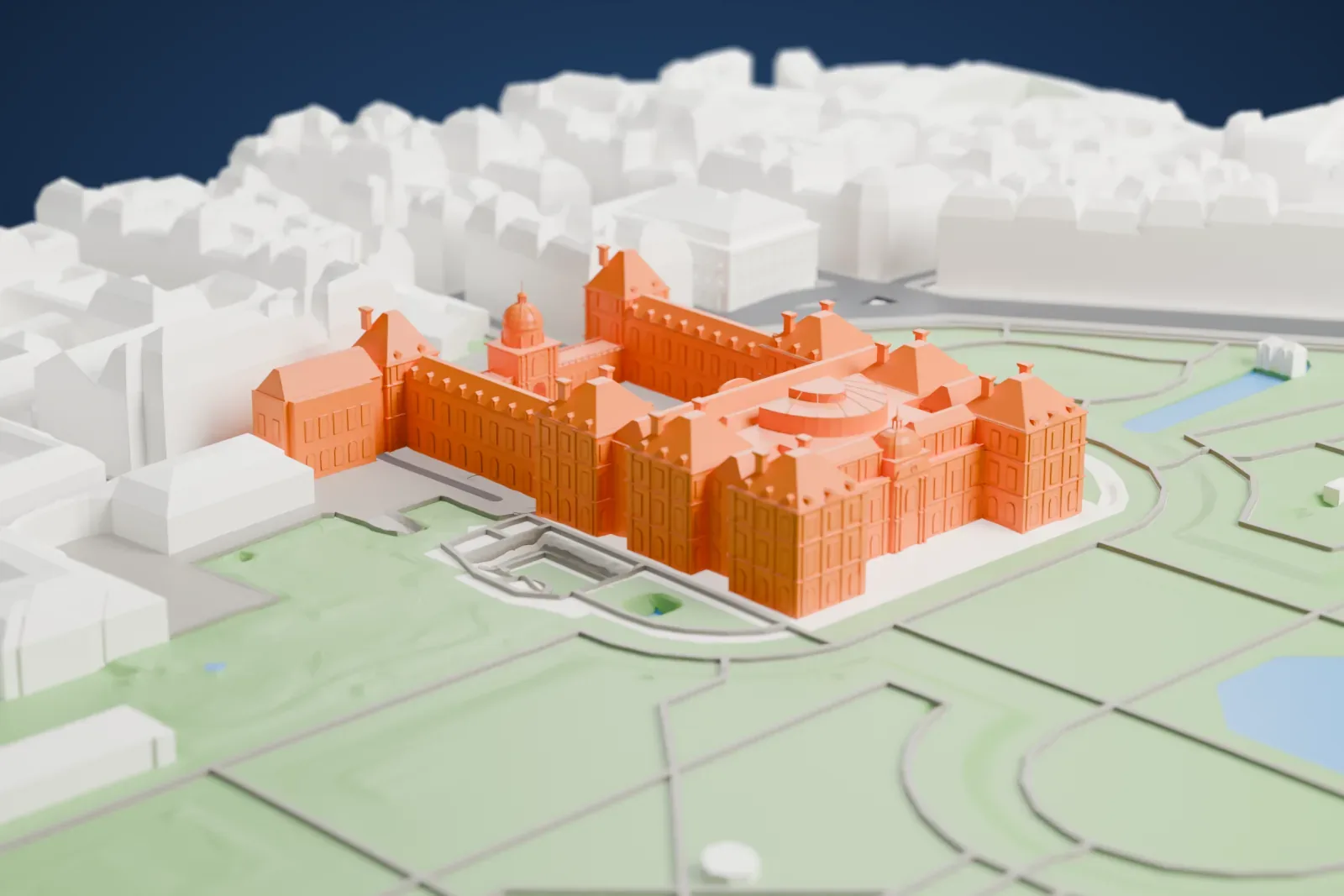 A white 3D print of the Palais du Luxembourg, a long palace block with garden on one side and city streets on the other.