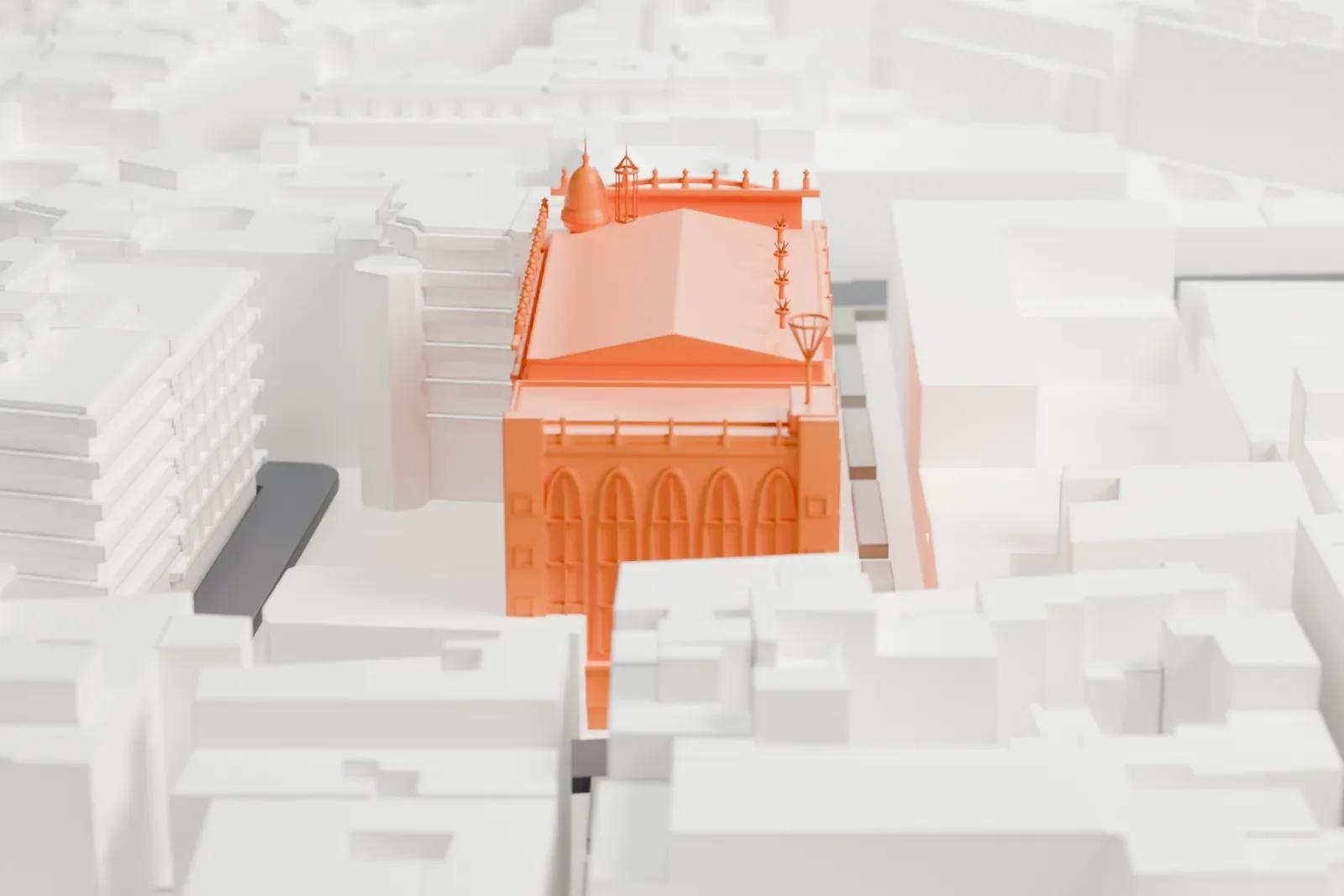 A white 3D print of the Palau de la Música Catalana, a boxy hall with tall arched windows, a small domed corner turret and a gabled roof, packed among dense, closely spaced city blocks.