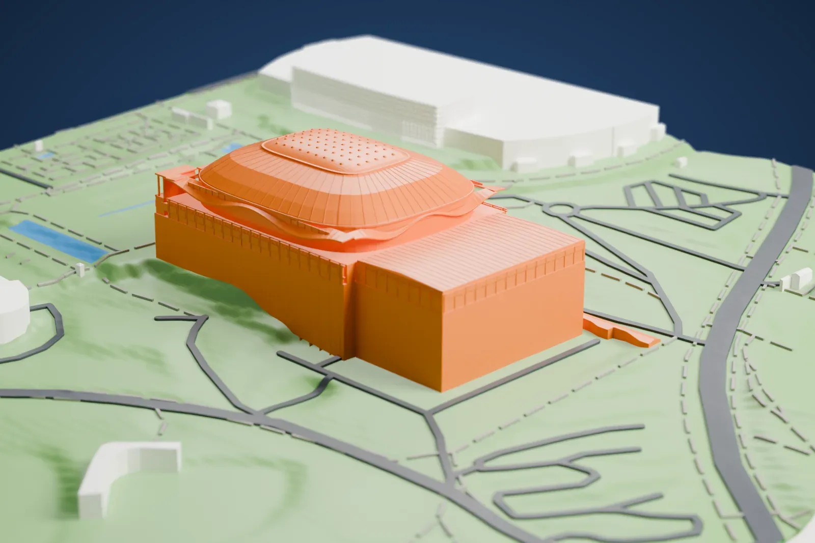 A white 3D print of Palau Sant Jordi, an arena with a ribbed dome roof and a lower block beside it, set on a green hillside with roads and a ring-shaped building nearby.