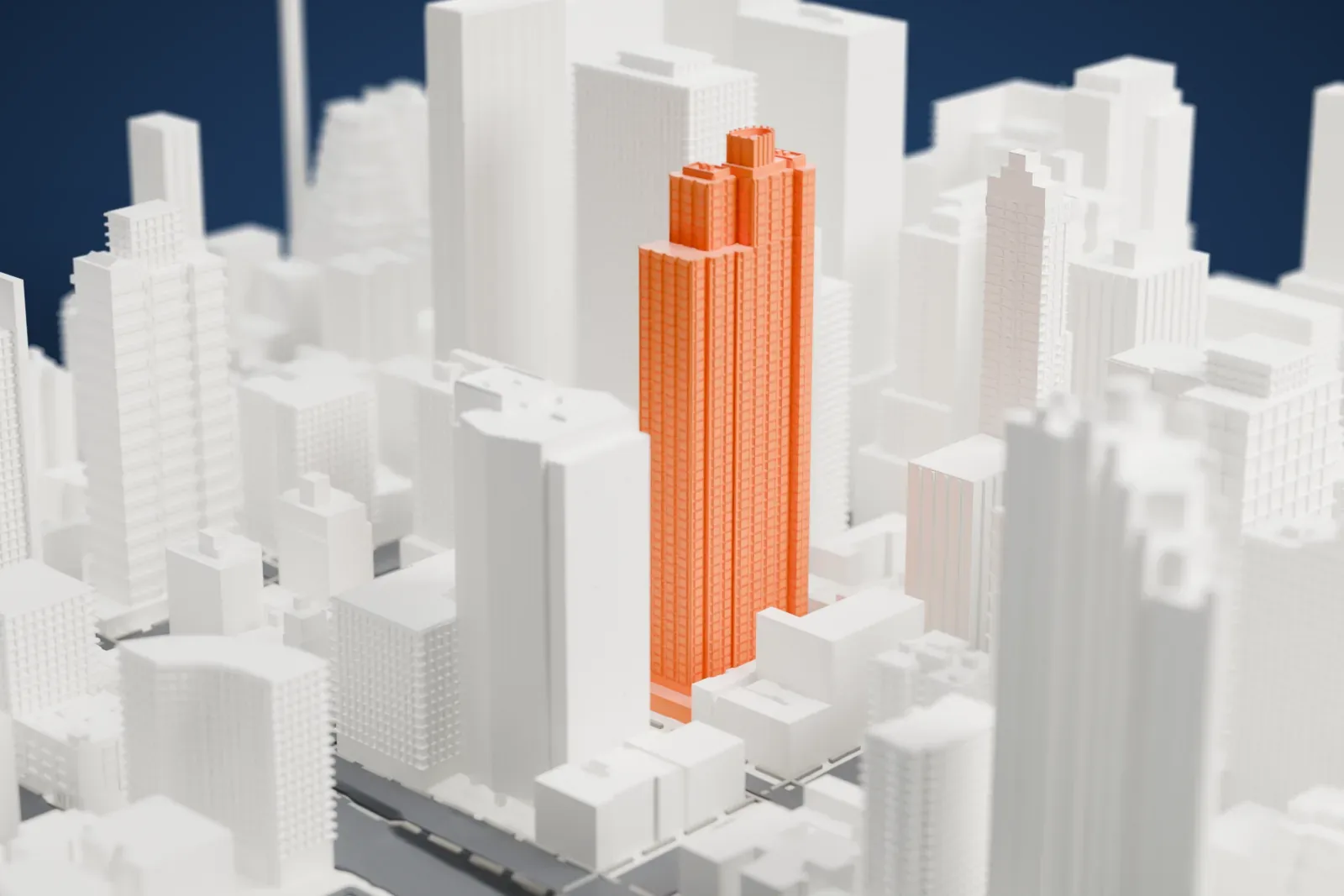 A white 3D print of the Paramount Tower, a tall stepped tower with vertical ribbing, rising among dense Midtown buildings.