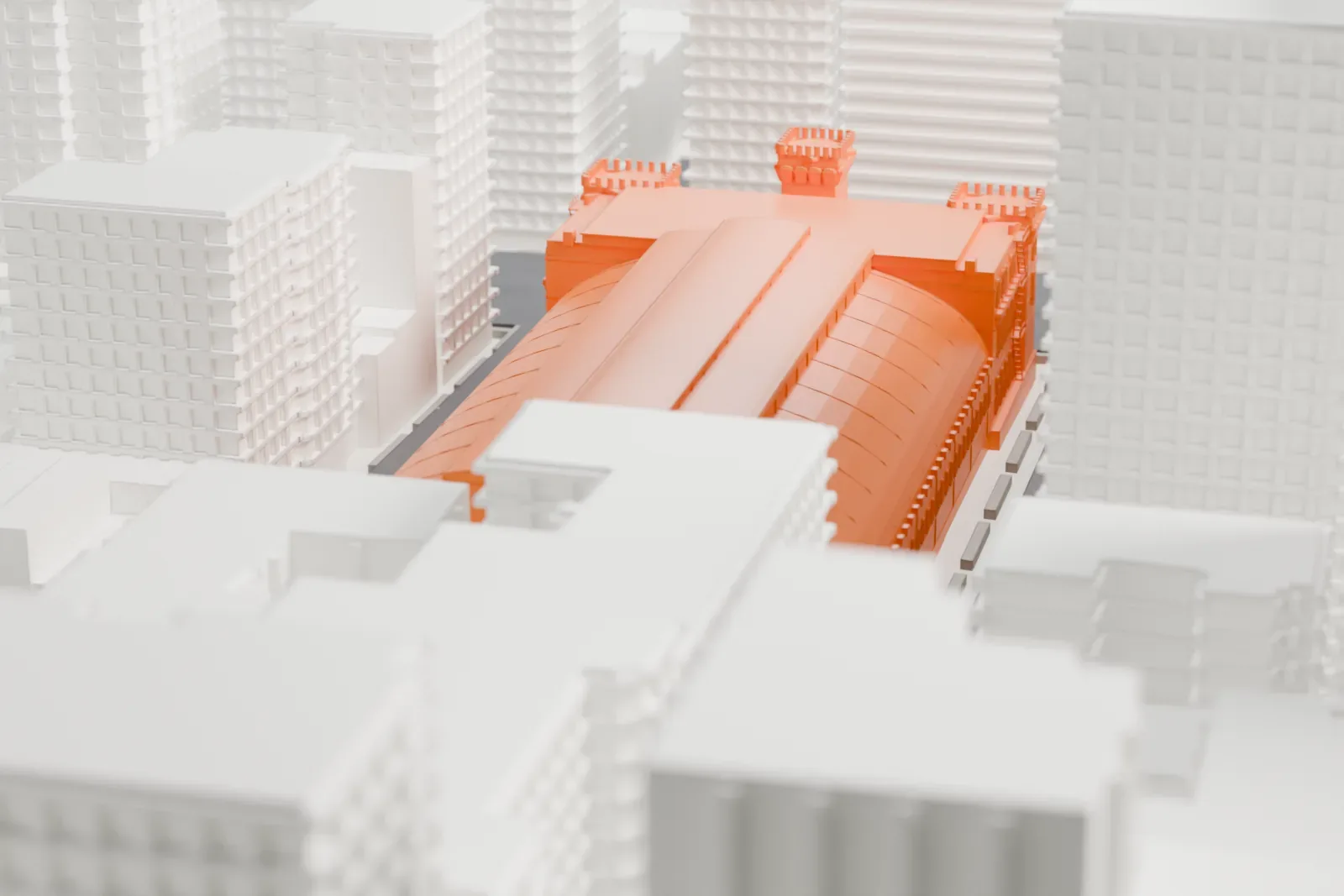 A white 3D print of the Park Avenue Armory, a long hall with a ribbed roof and a taller front building, surrounded by dense city blocks.