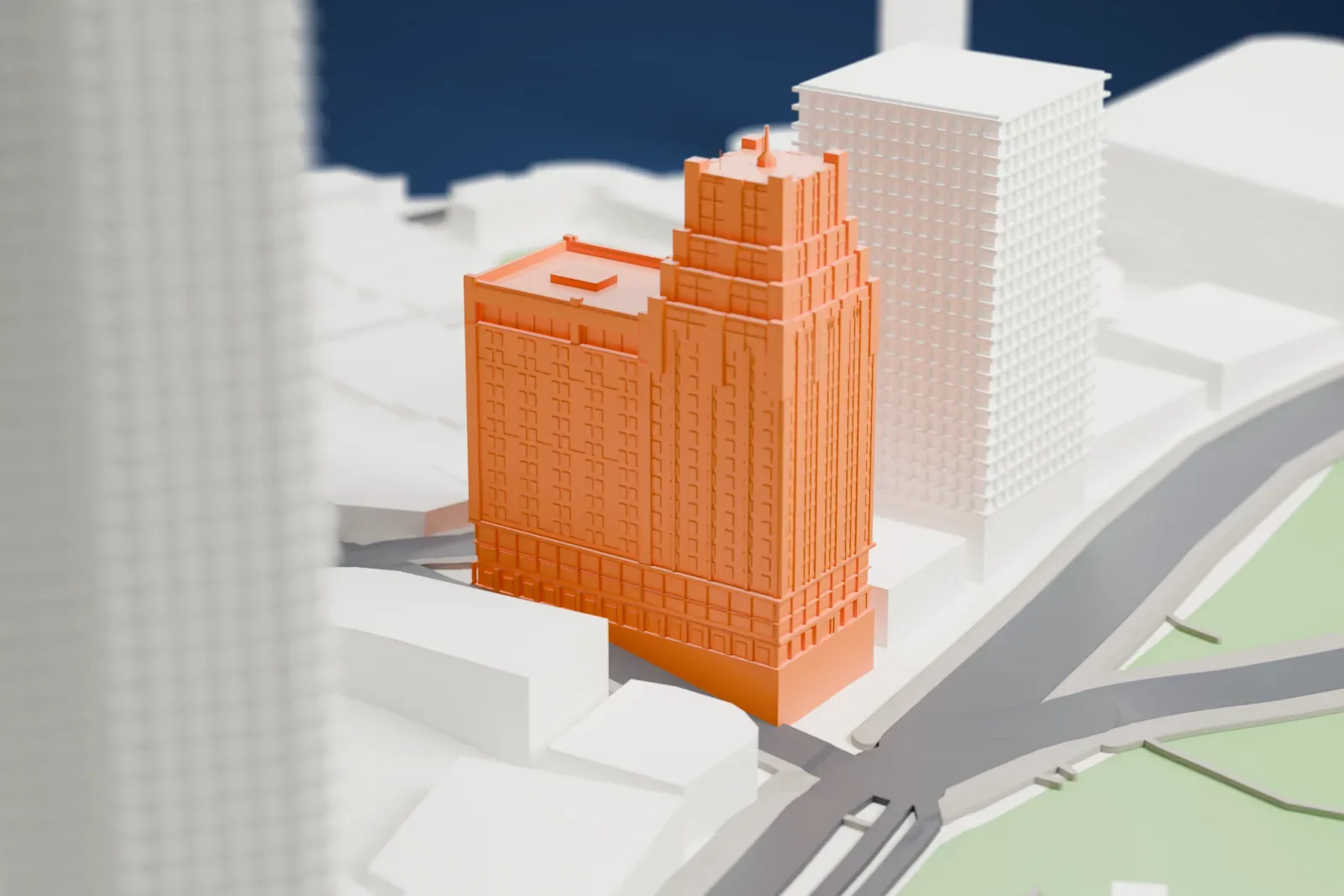 A white 3D print of the Park Hotel Shanghai, with its stepped Art Deco crown and long lower wing, among the surrounding city buildings.