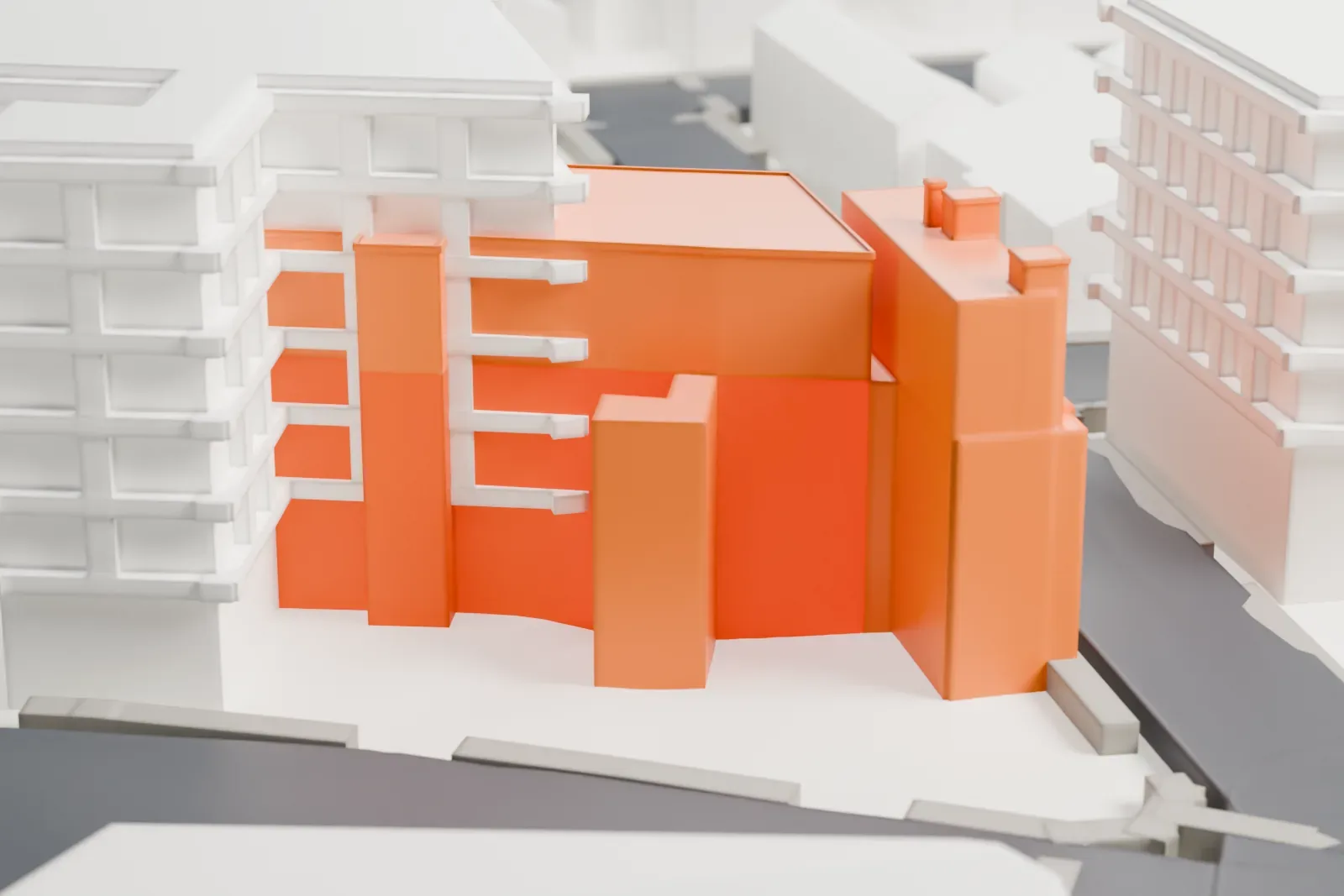 A white 3D print of the Park Performing Arts Center, a tall block-shaped building with a decorated entrance at one corner, on an open street corner among other buildings.