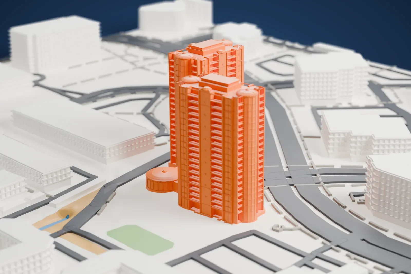 A white 3D print of Park Towers at Hughes Center, two tall rounded towers with corner turrets joined by a small round pavilion, among mid-rise buildings and curving roads.