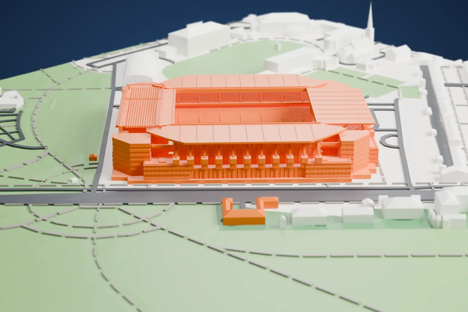 A white 3D print of Parken Stadium, a rectangular football stadium with ribbed roofs over four stands, standing among green parkland, sports fields and rows of low buildings.