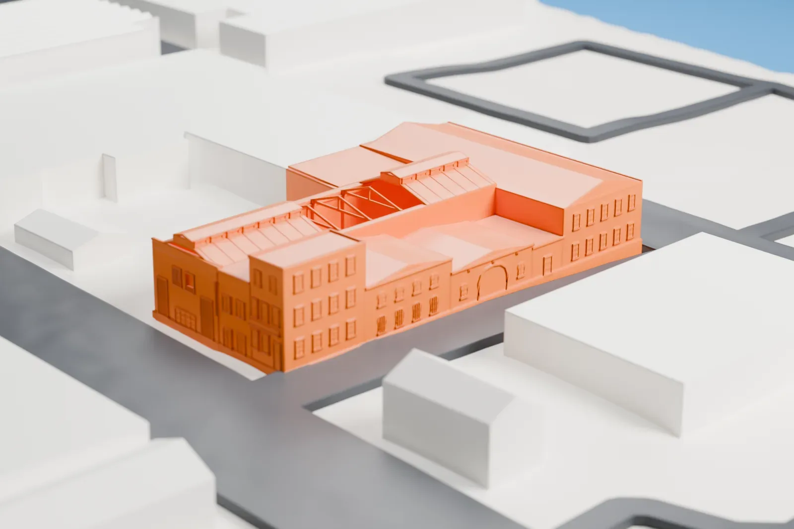 A white 3D print of the Passaic Machine Works, a long factory with several gabled roof sections, standing among streets and large industrial buildings.