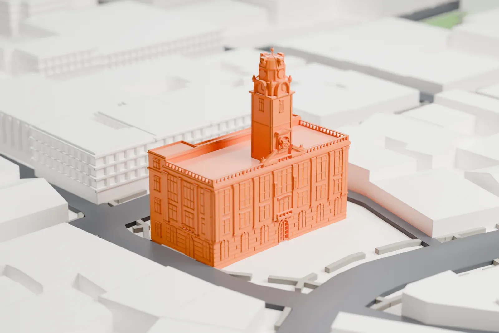 A white 3D print of Paterson City Hall, a stone building with a tall central clock tower and a domed top, standing on a block ringed by streets and low buildings.