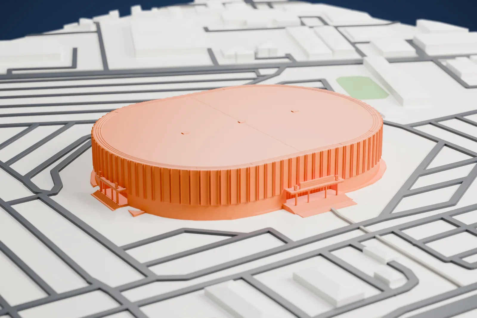A white 3D print of the Pechanga Arena, a low oval arena with a flat roof and a band of fins, surrounded by city streets and buildings.