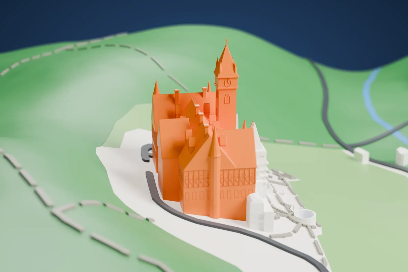 A white 3D print of Peleș Castle, with a tall spired tower and steep gabled roofs, on a wooded mountain slope with a small stream and nearby buildings.