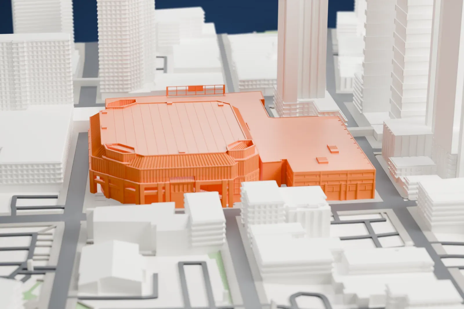 A white 3D print of PeoplesBank Arena, with its broad roof, corner towers and surrounding downtown streets and buildings.