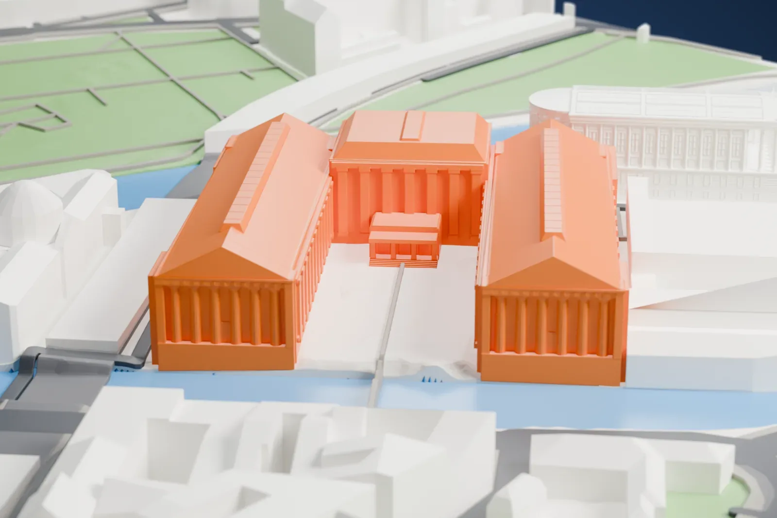 A white 3D print of the Pergamon Museum, a long museum building with three wings, standing among the streets and buildings of central Berlin.