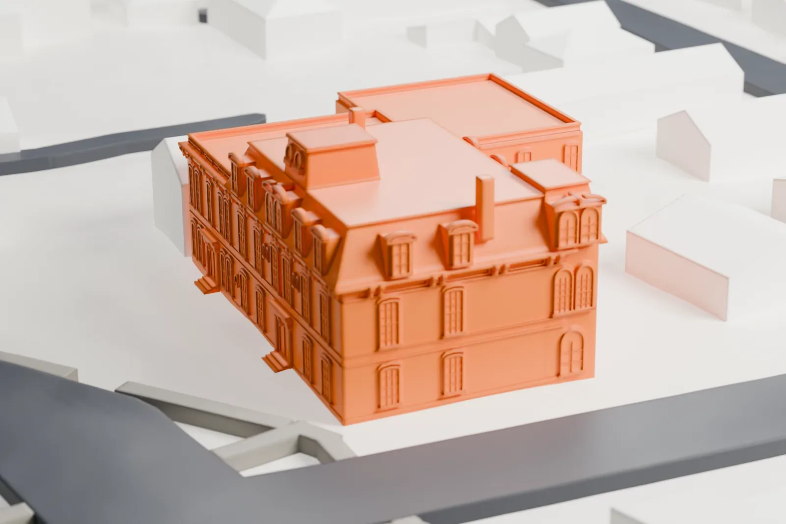 A white 3D print of Perth Amboy City Hall, a multi-wing building with dormers and a steep roof section, on a paved block beside a small park and roads.