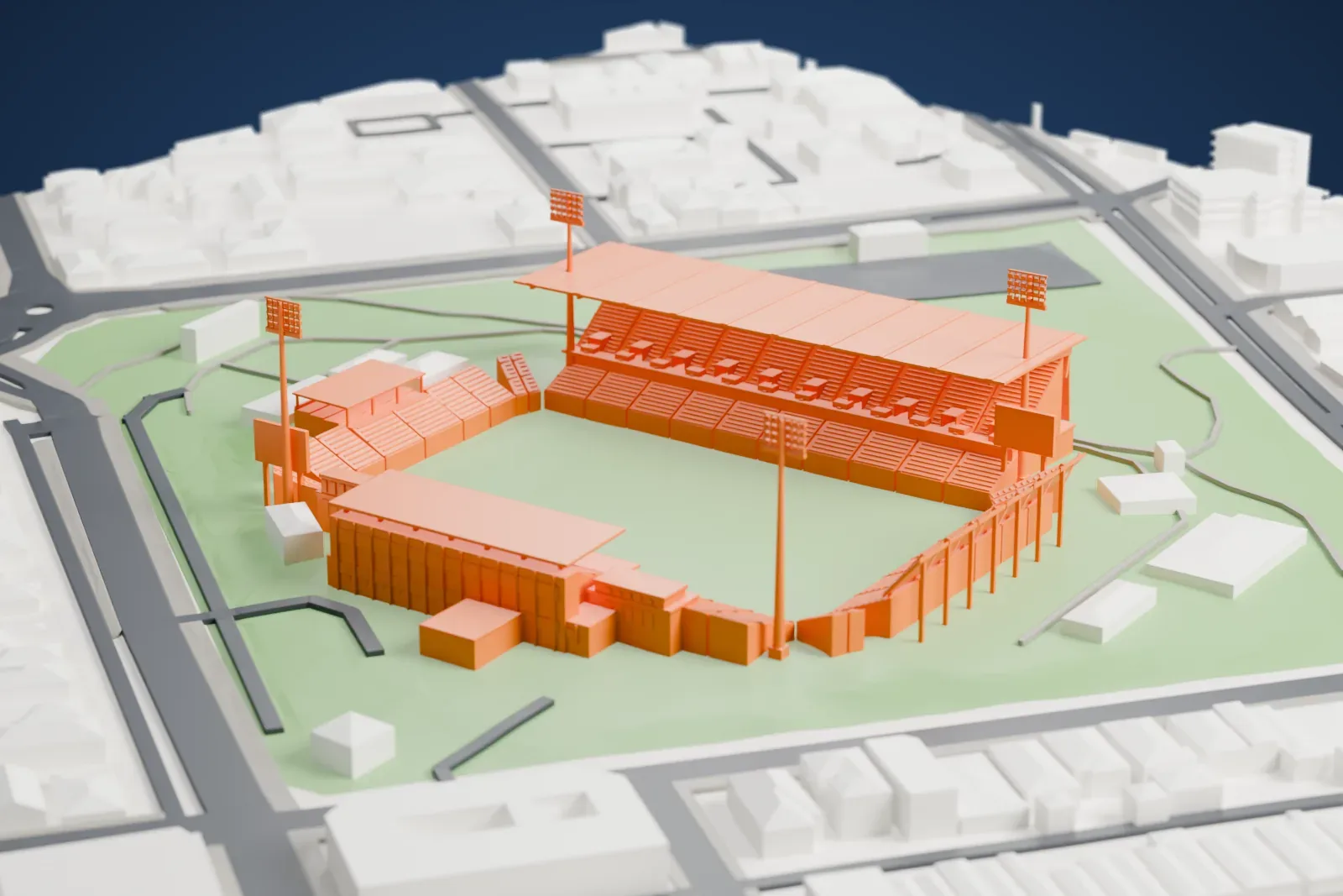 A white 3D print of Perth Rectangular Stadium, with its tall east grandstand, floodlight towers and surrounding streets and buildings.