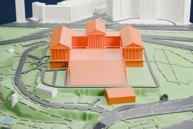 A white 3D print of the Philadelphia Museum of Art, a columned temple-style building with a wide terraced slope, standing on a hilltop ringed by roads and parkland.