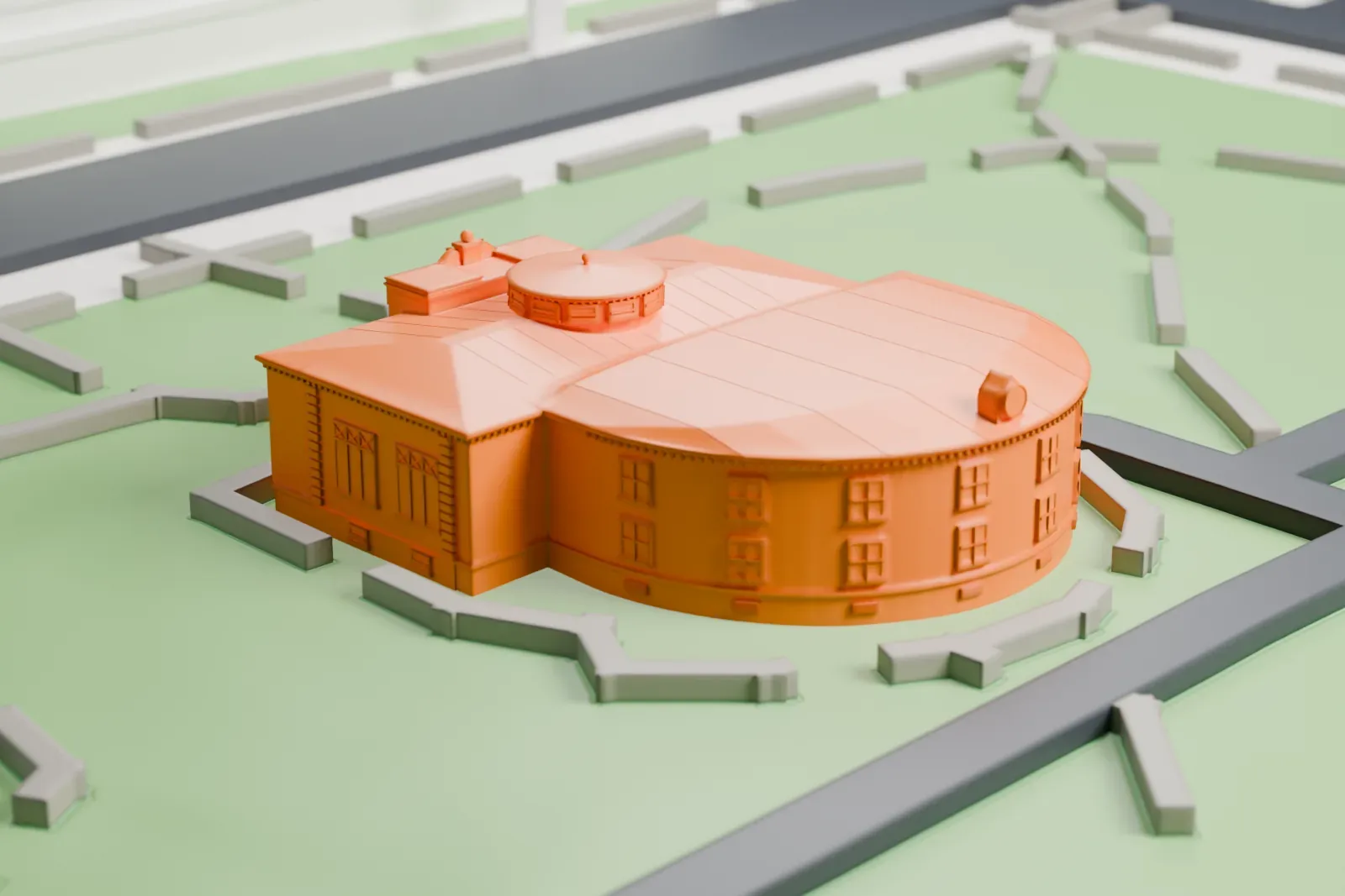 A white 3D print of the Phoenix Carnegie Library, a low building with a curved rear wing and a small rooftop lantern, on a green park with winding paths.