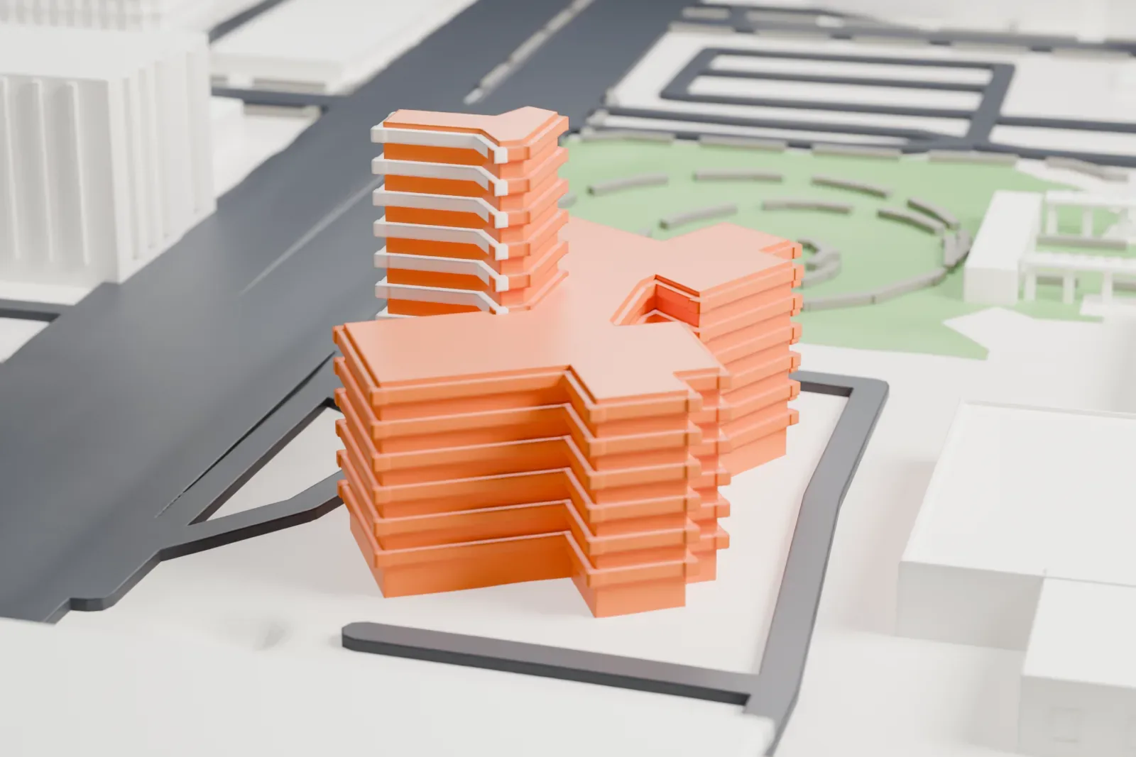 A white 3D print of the Phoenix Towers, a 14-story building with four wings in an X and projecting ledges on every floor, with roads and open ground around it.
