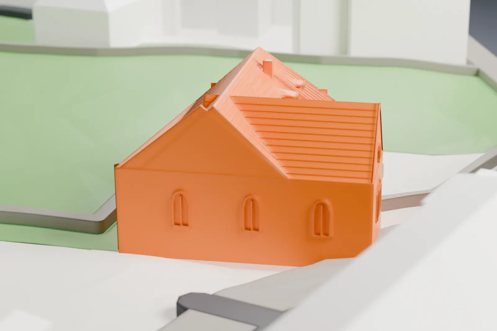 A white 3D print of the Pinkas Synagogue in Prague, a low synagogue among the surrounding streets and buildings of the Jewish Town.