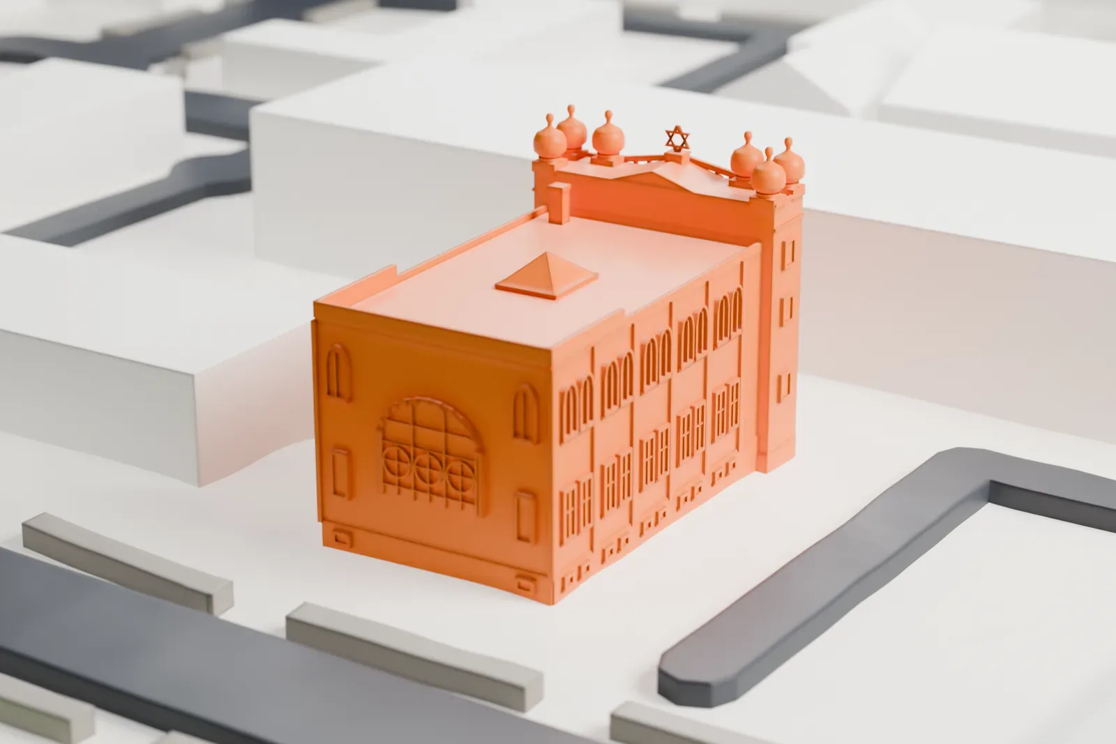 A white 3D print of Poile Zedek Synagogue, a boxy building with arched windows and small domes at its front corners, on a street corner with nearby roads and buildings.