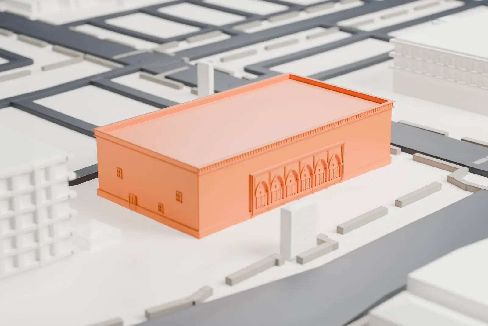A white 3D print of the Polly Rosenbaum Building, a large boxy hall with a flat roof and a row of arched entrances, beside a street and a larger neighboring building.