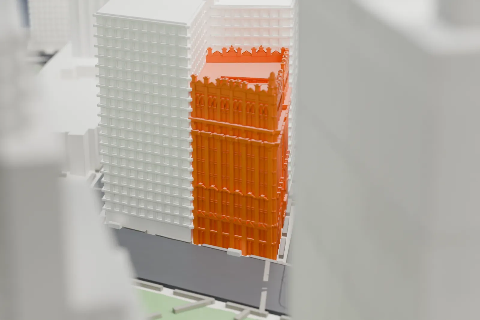 A white 3D print of the Potter Building, a tall, richly ornamented block with finials, standing among taller plain buildings near a park.