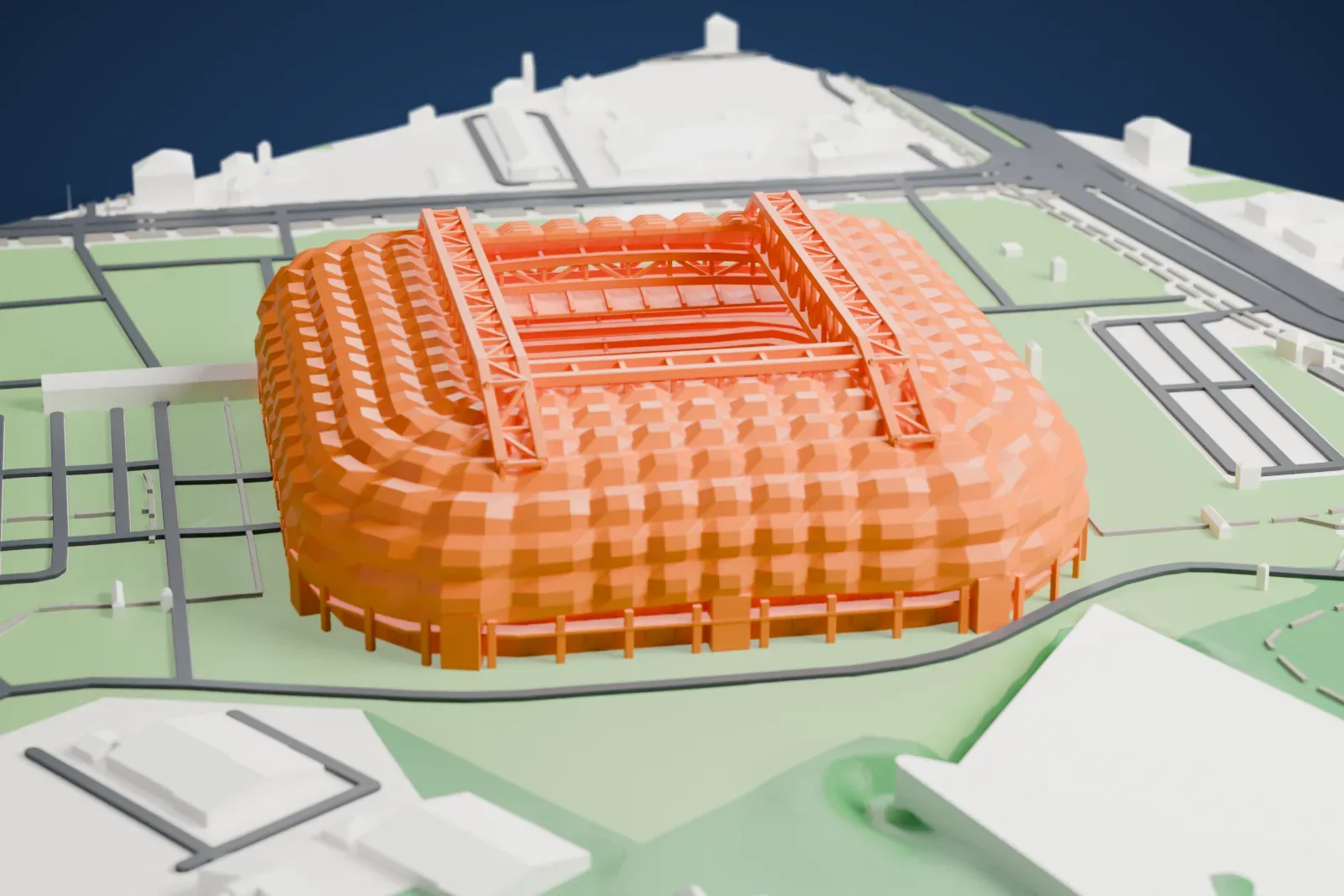 A white 3D print of Poznań Stadium, a low broad ring of quilted roof cushions with a rectangular opening over the pitch and a lower ribbed roof at one end, among the streets and buildings around it.