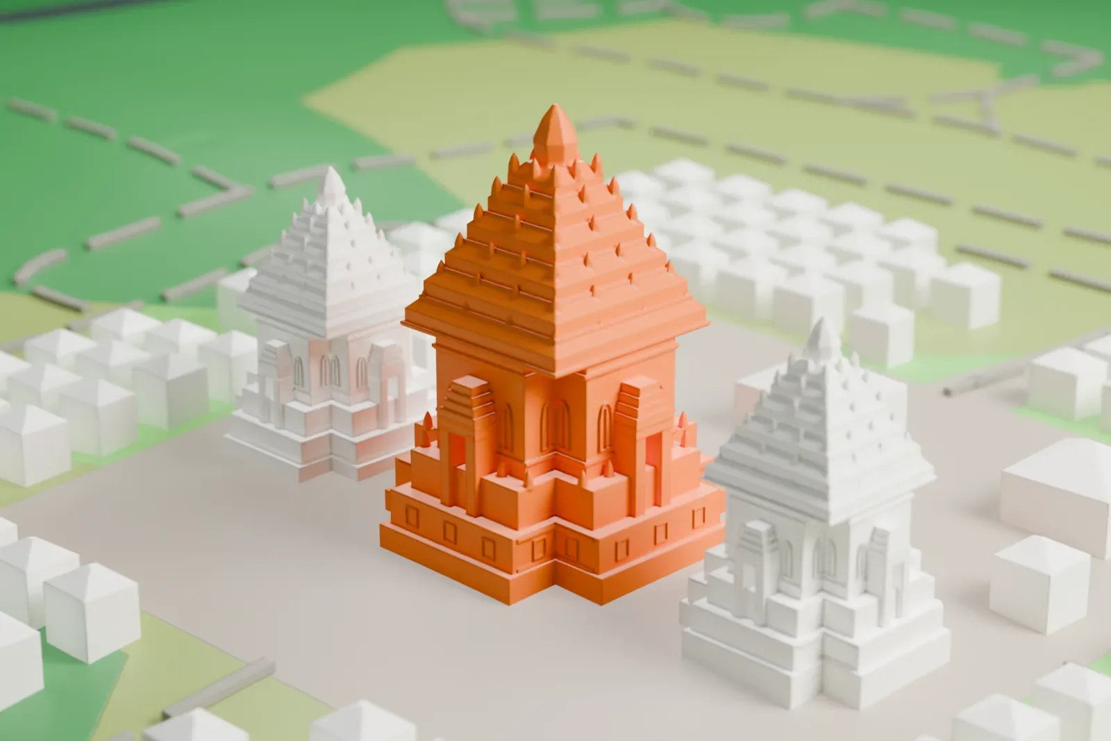A white 3D print of Prambanan, three tall pointed temple towers rising in tiers from a paved plaza, surrounded by rows of small buildings, green fields and a narrow waterway.