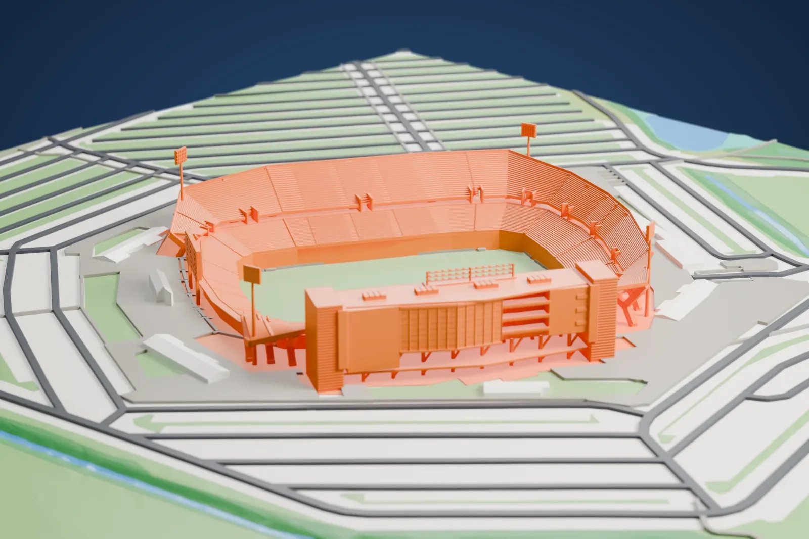 A white 3D print of Pratt & Whitney Stadium at Rentschler Field, with its open horseshoe bowl, lighting masts and long suite tower, among surrounding streets and buildings.
