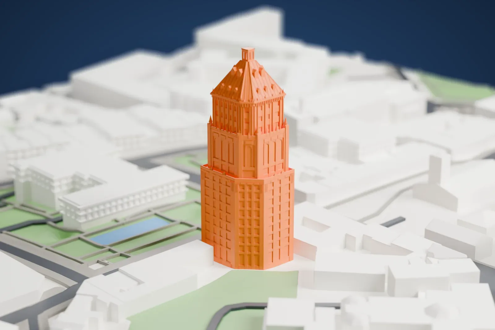 A white 3D print of the Price Building, a tall stepped skyscraper, among the surrounding streets and buildings of Quebec City.