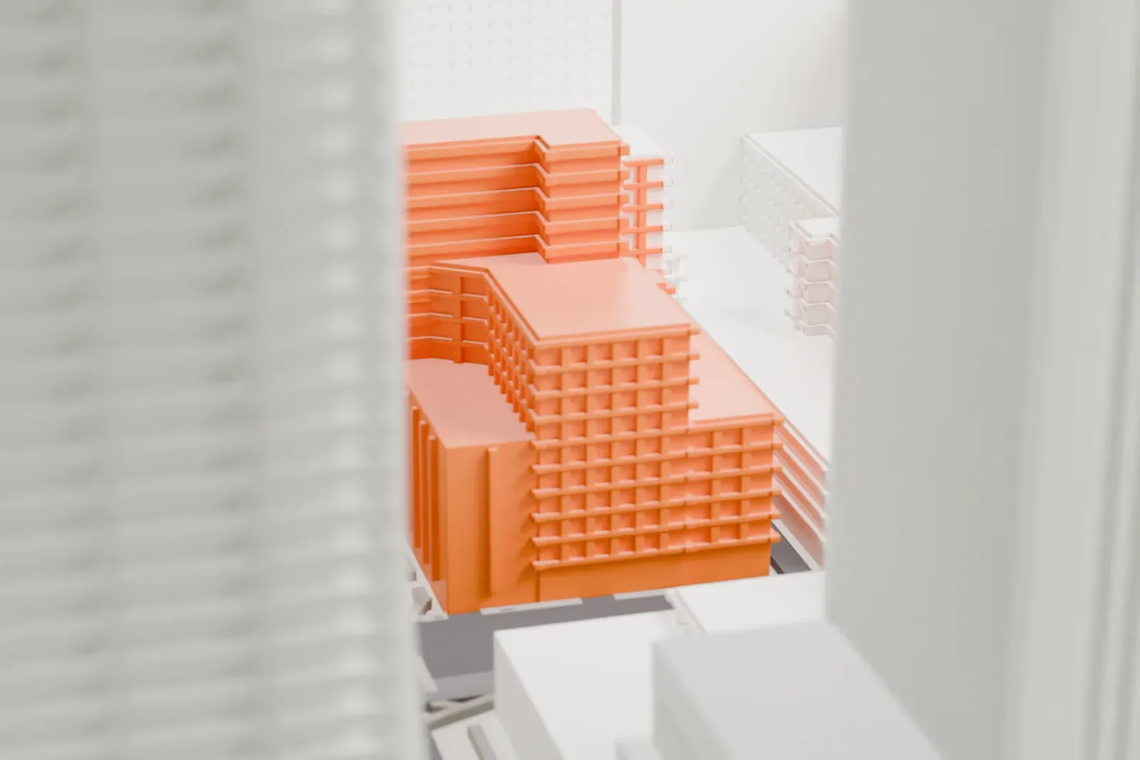 A white 3D print of the Professional Building, a narrow stepped tower with notched parapets squeezed beside a much larger building and a wide downtown street.
