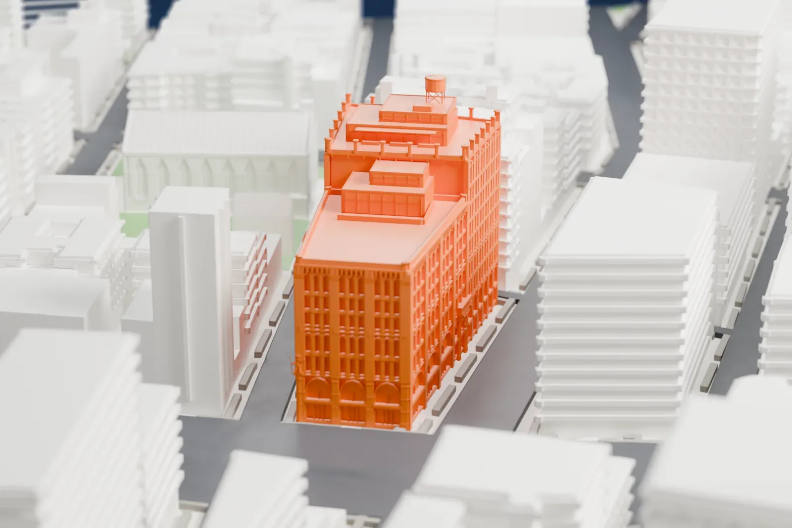 A white 3D print of the Puck Building, a tall brick block with stepped penthouses and a rooftop water tank, surrounded by lower buildings and streets.
