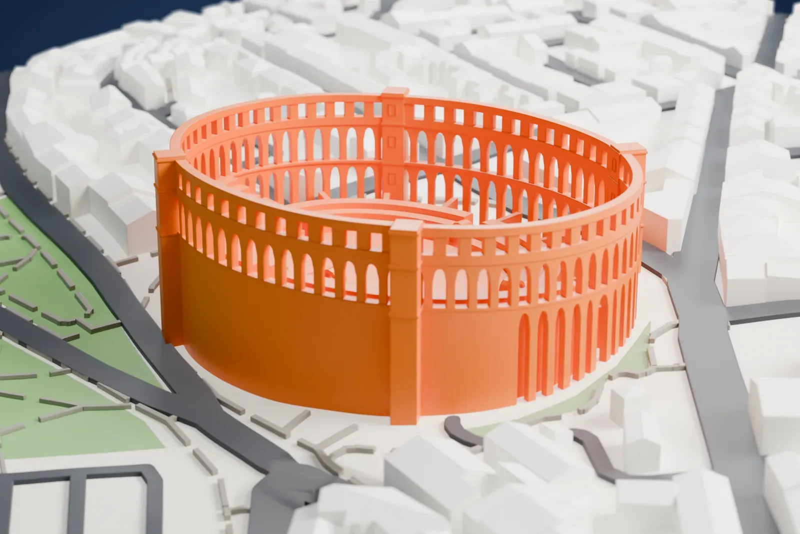 A white 3D print of the Pula Arena, an oval ring of arched walls around stepped seating, set among town streets and buildings with parkland and water at its edges.