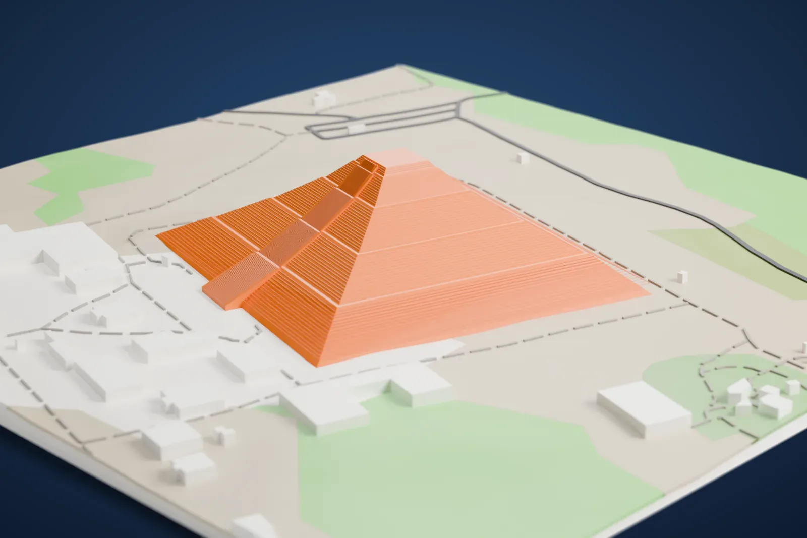A white 3D print of the Pyramid of the Sun, a large stepped pyramid with a staircase up one face, on open bare ground with paths, green patches and a few low buildings.