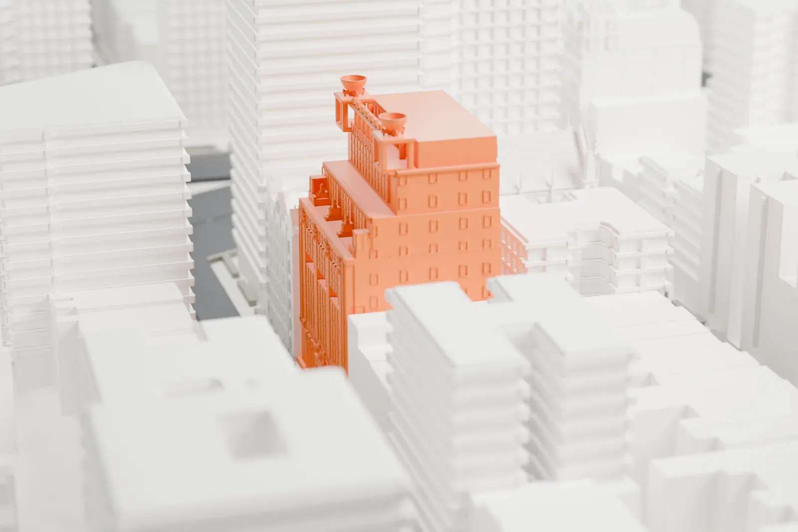 A white 3D print of the Pythian Temple, a stepped tower with rows of windows and two bowl-shaped urns on top, squeezed between taller buildings beside a church.
