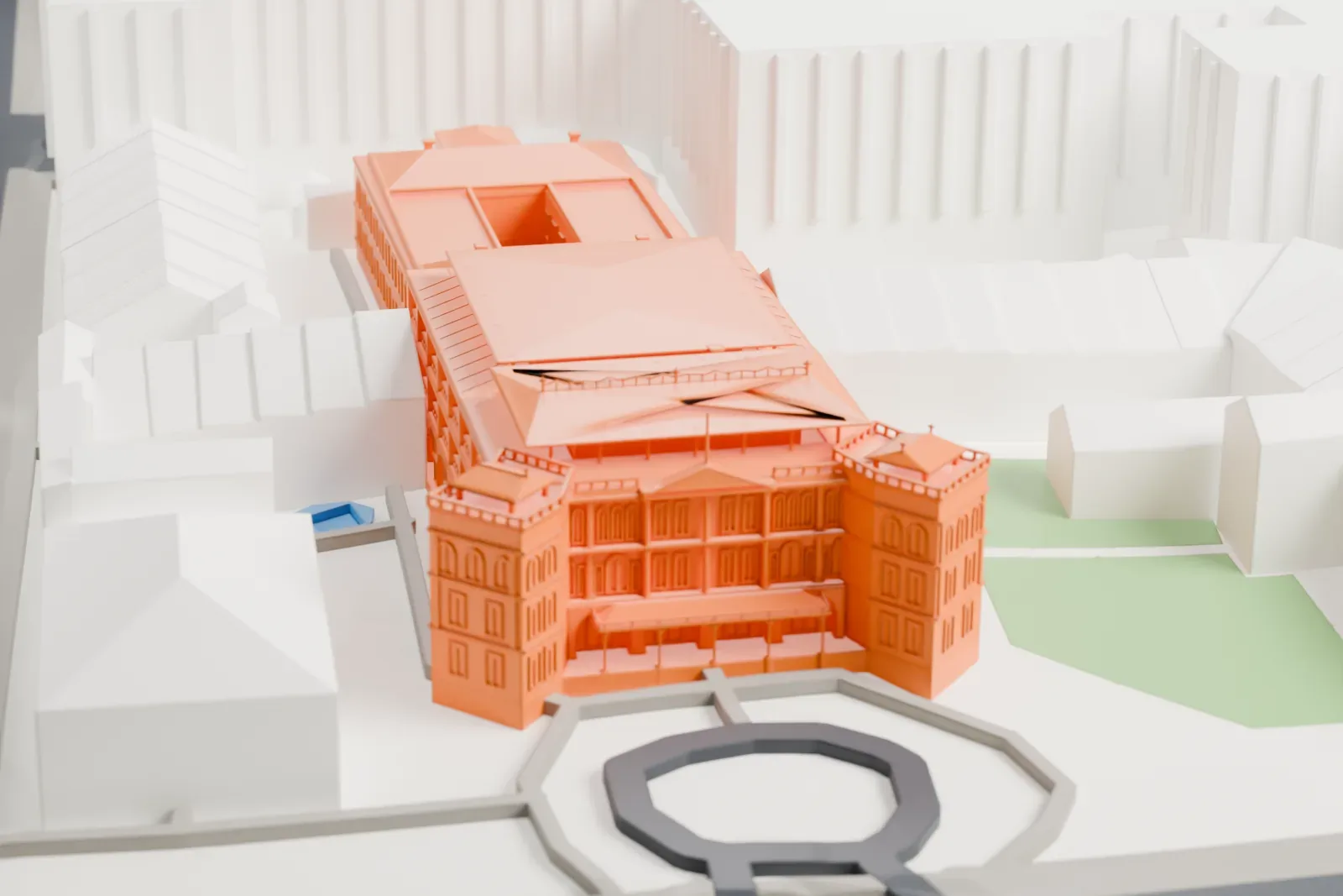 A white 3D print of Raffles Hotel in Singapore, shown among the surrounding streets and buildings.
