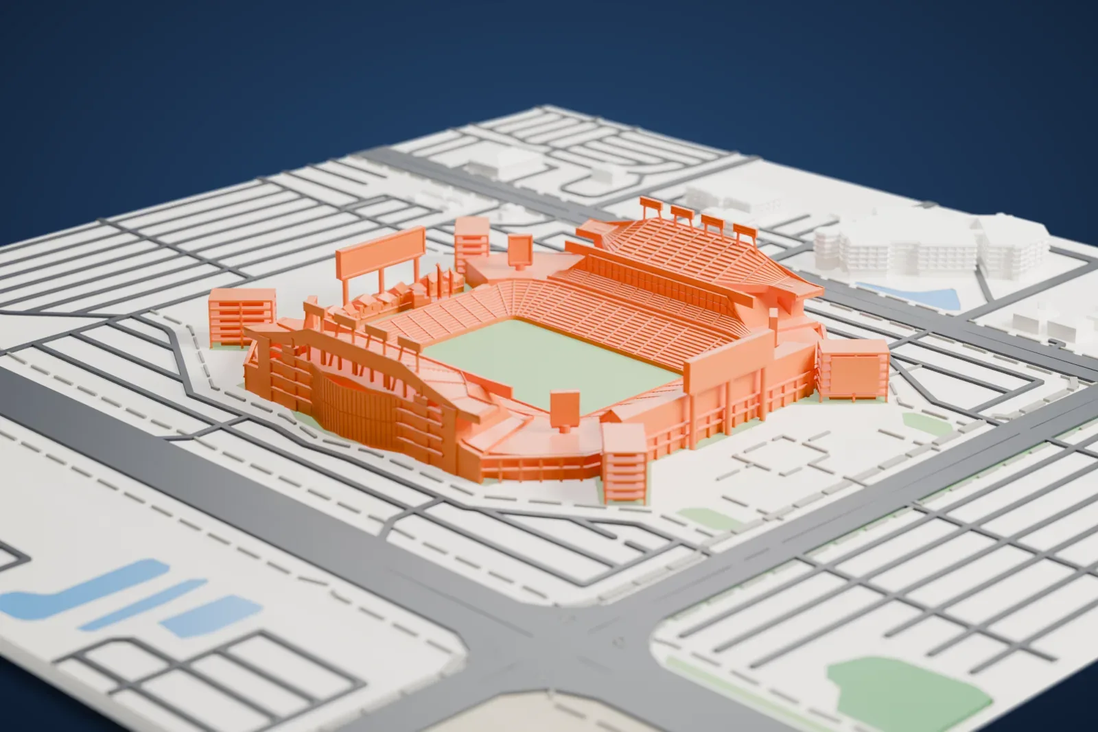 A white 3D print of Raymond James Stadium, an open bowl whose two long sides rise higher than the ends, with a small pirate ship behind one end, among the streets and buildings around it.