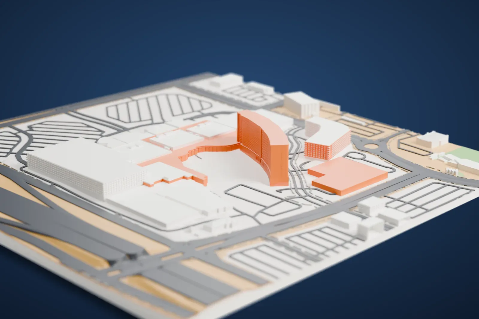 A white 3D print of Red Rock Casino, Resort & Spa, a long, low complex with a curved hotel tower at one end, surrounded by wide roads and large parking lots.